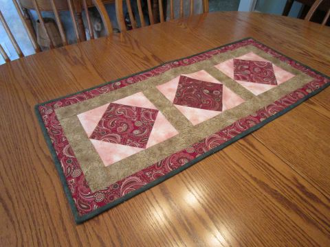 Table Runner 15” x 35” Brown, Pink, Tan patchwork.  Placemats to match.